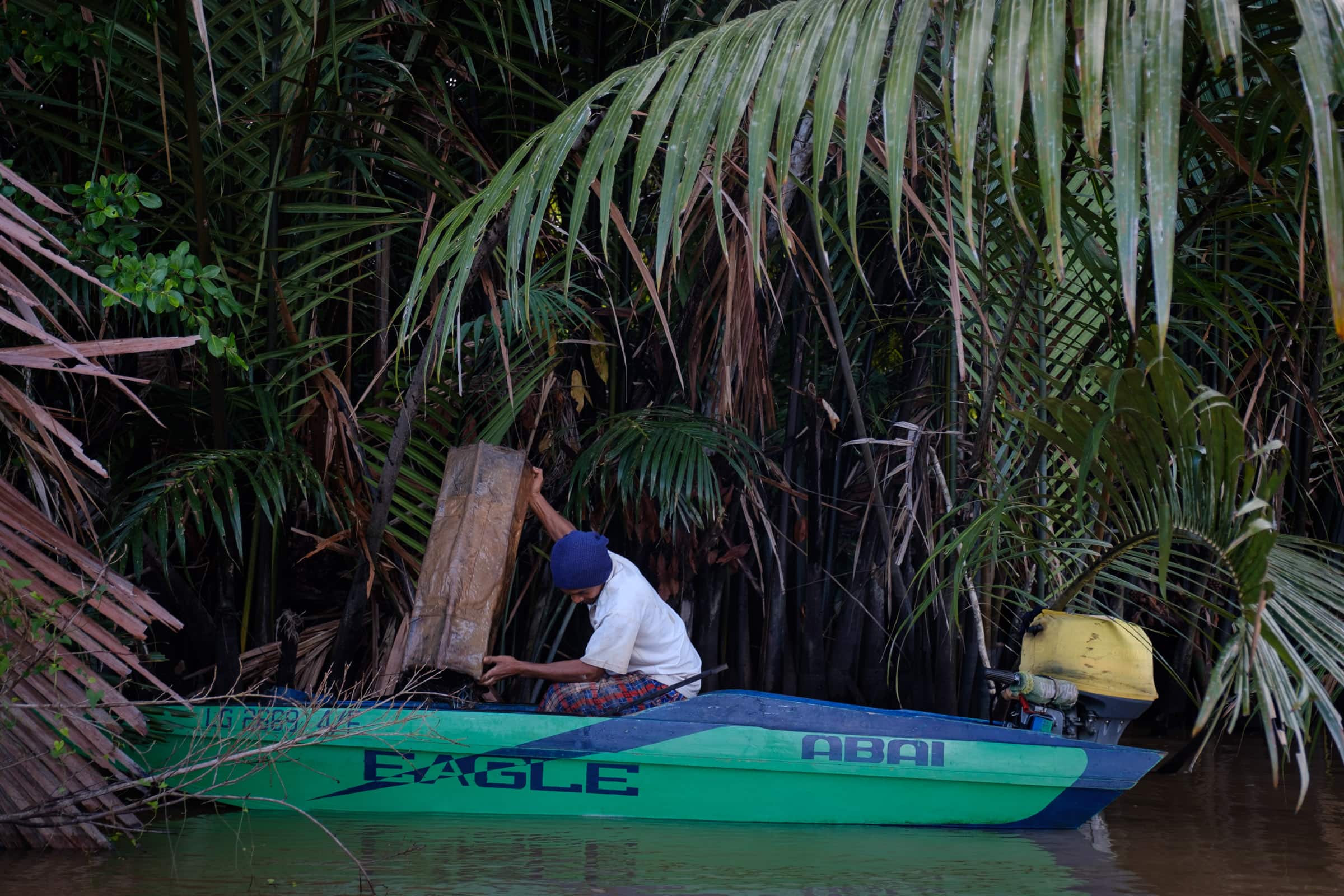 A fisherman checking on his bubu prawn trap.